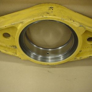 A yellow metal component with a large circular metallic bearing in the center and two smaller holes on either side, photographed against a plain background.